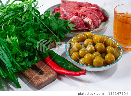 ingredients for cooking chakapuli, canned tkemali, meat, herbs Georgian cuisine, top view, ingredients for cooking chakapuli, canned tkemali, meat, herbs Georgian cuisine, top view, 133147394