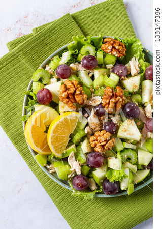 Fresh Waldorf salad, celery stalk with chicken, apple and walnuts, grapes, herbs, homemade, without people, Fresh Waldorf salad, celery stalk with chicken, apple and walnuts, grapes, herbs, homemade, without people, 133147396