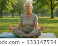 Elderly woman meditating outdoors Elderly woman meditating outdoors 133147554