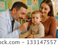 Pediatrician examining babys ear Pediatrician examining babys ear 133147557