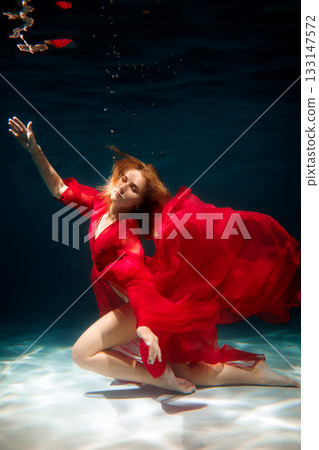 Modeled in luxurious crimson garments with striking glossy 133147572