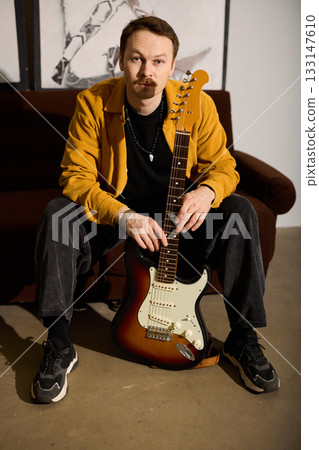 Detail shot of guitarist immersed in musical emotion and style 133147610