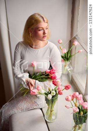 Gentle scene of woman embracing tranquil morning serenity indoors Gentle scene of woman embracing tranquil morning serenity indoors 133147624
