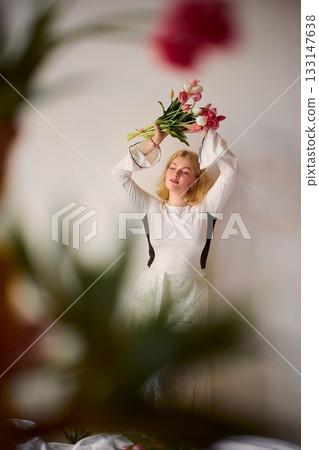 Lighthearted shot of woman adjusting floral headwear in spring 133147638