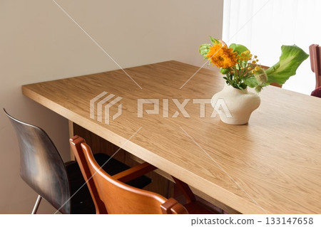 Delicate scene showcasing bright yellow flowers on warm wooden Delicate scene showcasing bright yellow flowers on warm wooden 133147658