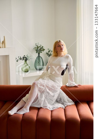 Selfassured influencer exudes grace in contemporary room setting 133147664