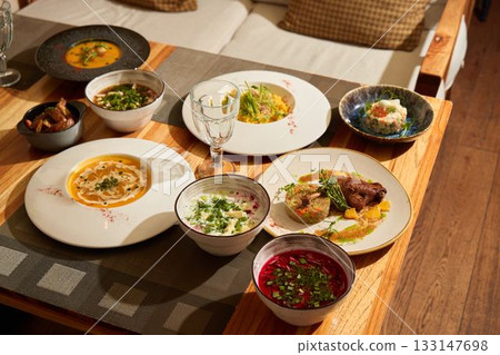 An Exquisite Global Cuisine Spread Tastefully Arranged on a Beautiful Wooden Table 133147698