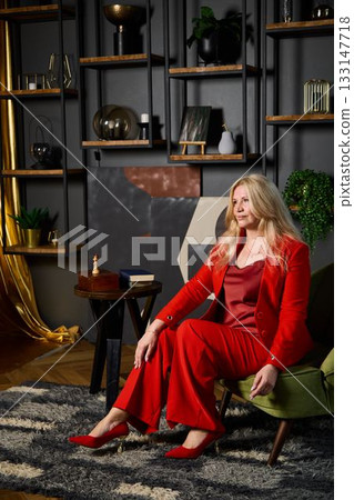stylish woman in modern room, professional woman seated confidently in luxurious modern living space 133147718