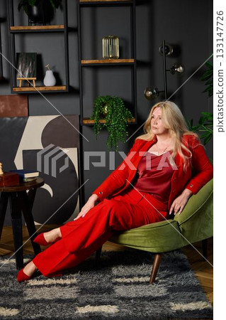 woman gazing upward with inspiration, caucasian woman in red suit inspiring with confident posture woman gazing upward with inspiration, caucasian woman in red suit inspiring with confident posture 133147726