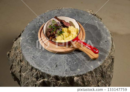 A Gourmet Dish featuring Tender Beef and Creamy Polenta elegantly served with style 133147759