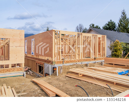 Wooden frame of new building with engineered lumber materials in front 133148216
