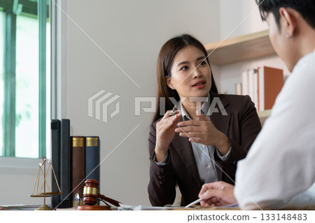 Legal Advice. A lawyer providing guidance to a client in a modern office. 133148483