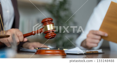 Legal Representation. Gavel and contract documents on a lawyer's desk during a consultation. Legal Representation. Gavel and contract documents on a lawyer's desk during a consultation. 133148488
