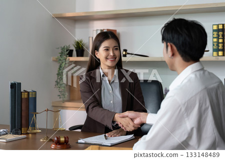 Legal Consultation. Professional lawyer shaking hands with a client in an office. 133148489