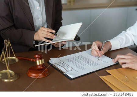 Legal Agreement. Lawyer presenting contract for signature in office. Legal Agreement. Lawyer presenting contract for signature in office. 133148492