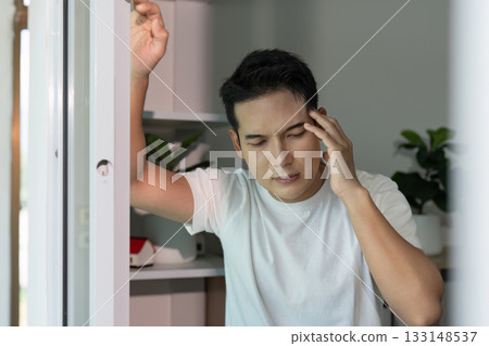 Mental Health Awareness. Young man experiencing stress and anxiety at home. Mental Health Awareness. Young man experiencing stress and anxiety at home. 133148537