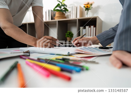 Creative Team Discussing Design Ideas with Color Tools 133148587