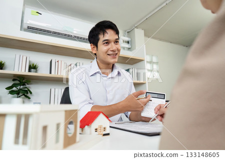 Real Estate Agent Presenting Property Model to Client Real Estate Agent Presenting Property Model to Client 133148605