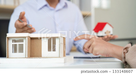 Real Estate Agent Explaining Property Model to Client 133148607