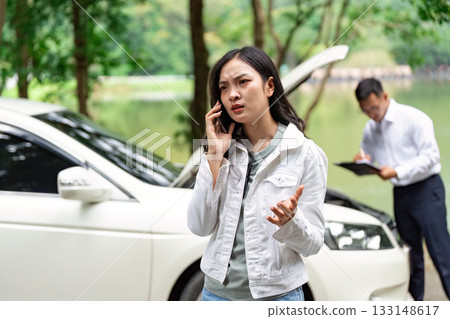 Insurance Emergency. Woman on phone during vehicle breakdown. Insurance Emergency. Woman on phone during vehicle breakdown. 133148617
