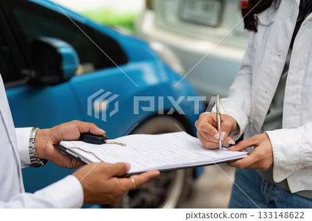 Insurance. Client signing car insurance documents with agent outdoors. Insurance. Client signing car insurance documents with agent outdoors. 133148622