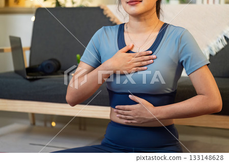 Mindfulness and Wellness. Woman practicing deep breathing and meditation at home. 133148628