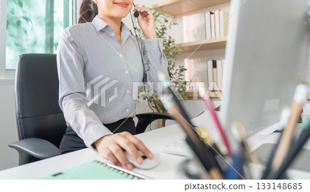 Remote Work. Young professional woman using headset for virtual customer support. Remote Work. Young professional woman using headset for virtual customer support. 133148685