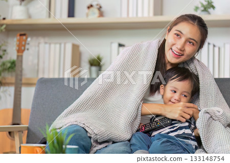 Cozy moments of a mother and son under a blanket 133148754