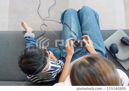 Mother and child gaming together, sharing moments of joy 133148800