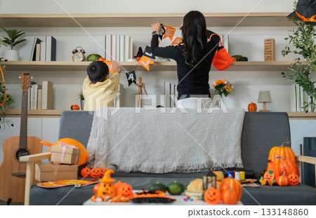 Halloween Decorations. Family bonding while setting up festive decor. Halloween Decorations. Family bonding while setting up festive decor. 133148860