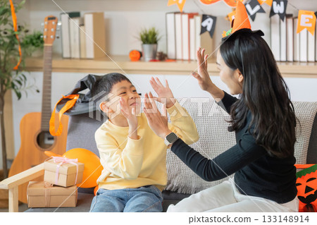 Halloween Decorations. Family preparing Halloween decor with joy and creativity. Halloween Decorations. Family preparing Halloween decor with joy and creativity. 133148914