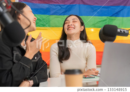 LGBTQIA women enjoying a light-hearted moment in a podcast studio LGBTQIA women enjoying a light-hearted moment in a podcast studio 133148915