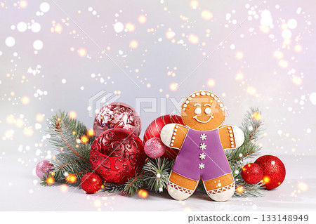 Happy New Year. Festive winter greeting card, gingerbread and Christmas decorations on snowy fir branches, Christmas Eve concept, New Year's background with lights and decorations Happy New Year. Festive winter greeting card, gingerbread and Christmas decorations on snowy fir branches, Christmas Eve concept, New Year's background with lights and decorations 133148949