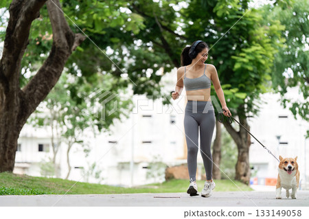 Active Lifestyle. Woman Jogging with Dog in Urban Park Active Lifestyle. Woman Jogging with Dog in Urban Park 133149058