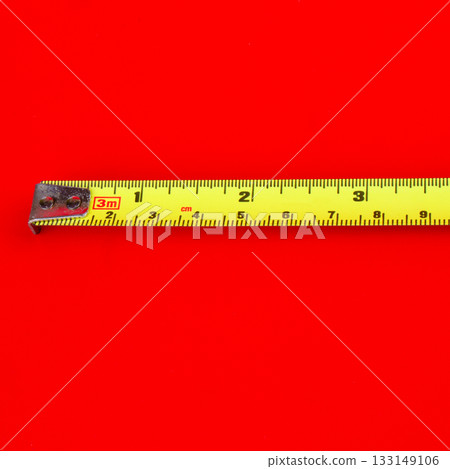Tape measure on a red background Tape measure on a red background 133149106