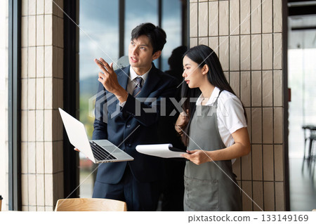 Strategic Planning. Businessman explaining ideas to a female employee in an office. 133149169