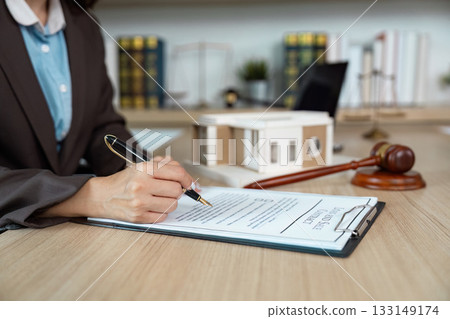Lawyer Signing Legal Agreement at Desk 133149174