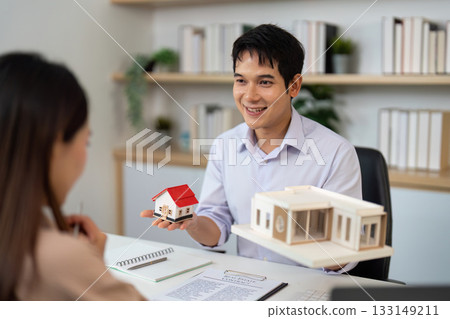 Real Estate Agent Presenting Property Models to Client in Office. 133149211