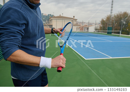 Close Up Of A Tennis Player Preparing To Return A Shot On A Blue Tennis Court 133149283