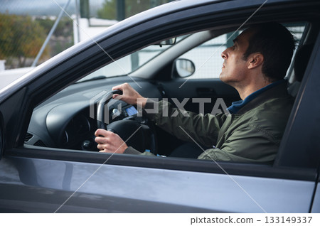 Man Driving Car. Side Profile With Hands On Steering Wheel Inside Modern Vehicle Man Driving Car. Side Profile With Hands On Steering Wheel Inside Modern Vehicle 133149337