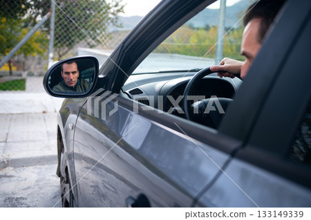 Focused Driver Inside Modern Car With Side Mirror Reflection For Stock Image Focused Driver Inside Modern Car With Side Mirror Reflection For Stock Image 133149339