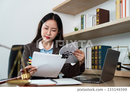 Lawyer Reviewing Legal Documents in Office 133149399