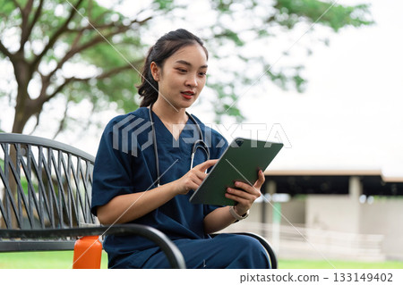 Doctor using tablet outdoors, enhancing patient care 133149402