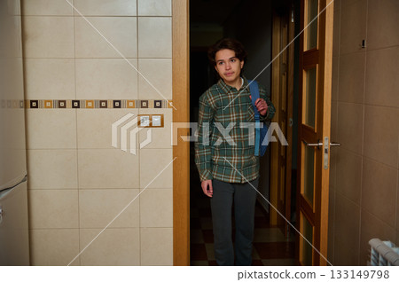 Teen Boy With Backpack Standing In Kitchen Doorway On A School Day 133149798