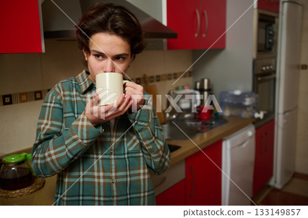 Teen Boy Drinking Coffee In Modern Kitchen After School, Casual Morning Moment Teen Boy Drinking Coffee In Modern Kitchen After School, Casual Morning Moment 133149857