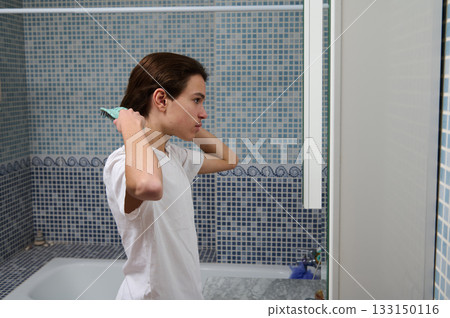 Teenager Grooming In Bathroom Mirror While Combing Hair For School Teenager Grooming In Bathroom Mirror While Combing Hair For School 133150116