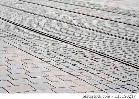 Detail on steel tram rail tiled stone floor around 133150237