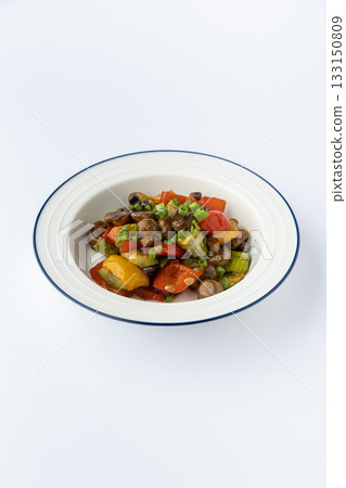 Sauteed mushrooms with bell peppers and zucchini, garnished with scallions, studio shot 133150809