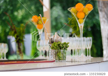 Outdoor bar with fresh mint, bar tools and citrus centerpieces ready for cocktails Outdoor bar with fresh mint, bar tools and citrus centerpieces ready for cocktails 133150820
