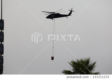 Bucket carrying helicopter. High quality photo Bucket carrying helicopter. High quality photo 133151255